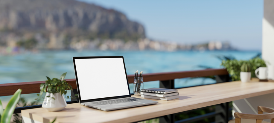 Laptop workspace overlooking the ocean
